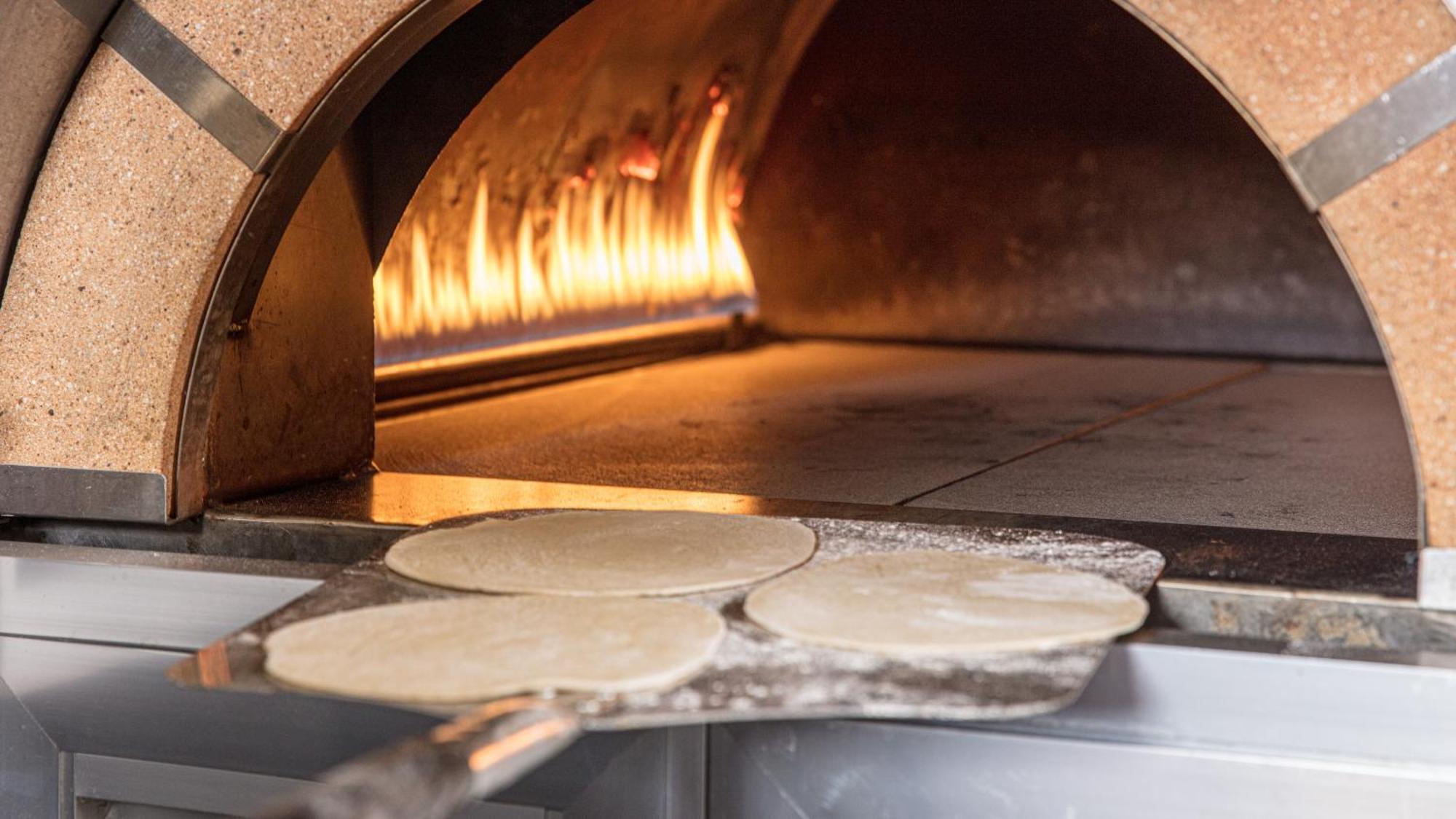 The Abdali Boulevard Hotel Амман Экстерьер фото Pizza dough in a wood-fired oven